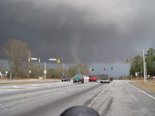 Tornado as seen from a vehicle on a road.